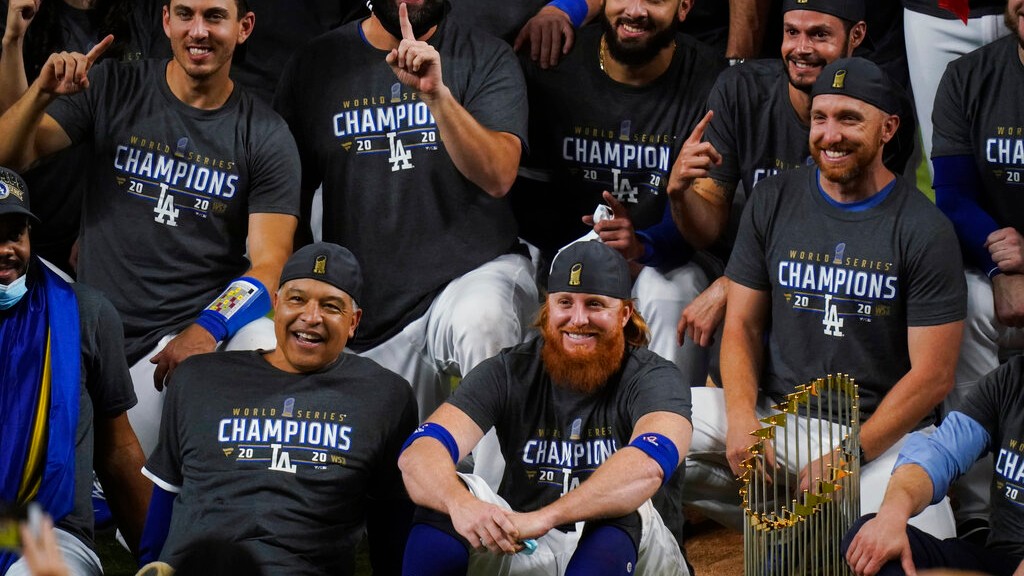 Los Angeles Dodgers manager Dave Roberts and third baseman Justin Turner pose for a group picture after the Dodgers defeated the Tampa Bay Rays 3-1 in Game 6 to win the baseball World Series, Tuesday, Oct. 27, 2020, in Arlington, Texas. (AP Photo/Eric Gay)