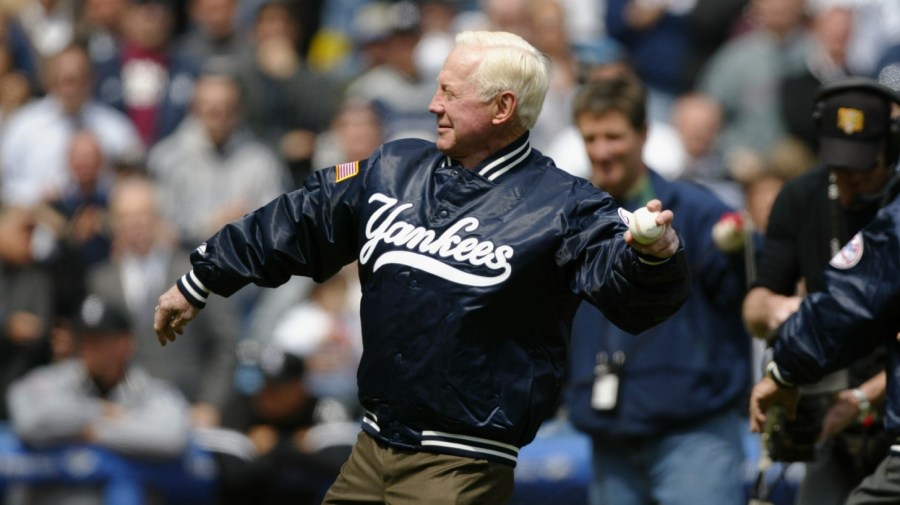 New York Yankees legend Whitey Ford (front) throws out the first pitch along with Yogi Berra before the game against the Chicago White Sox on April 8, 2004 at Yankee Stadium in the Bronx, New York. (Photo by Ezra Shaw/Getty Images)