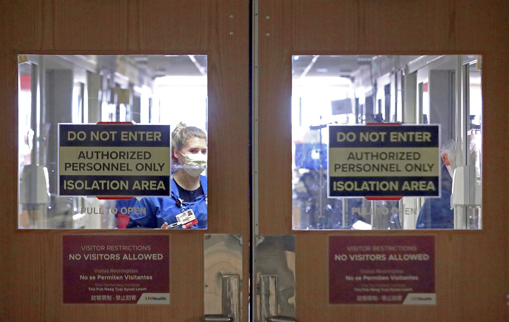 In this Nov. 5, 2020, photo, doors to a COVID-19 treatment unit at UW Health in Madison, Wisconsin, caution hospital personnel and visitors. (John Hart/Wisconsin State Journal via Associated Press)