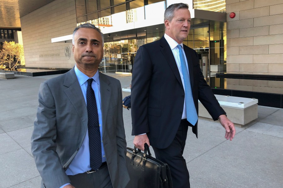 Imaad Zuberi, left, leaves the federal courthouse in Los Angeles with his attorney Thomas O'Brien, right, on Nov. 22, 2019. (Brian Melley / Associated Press)