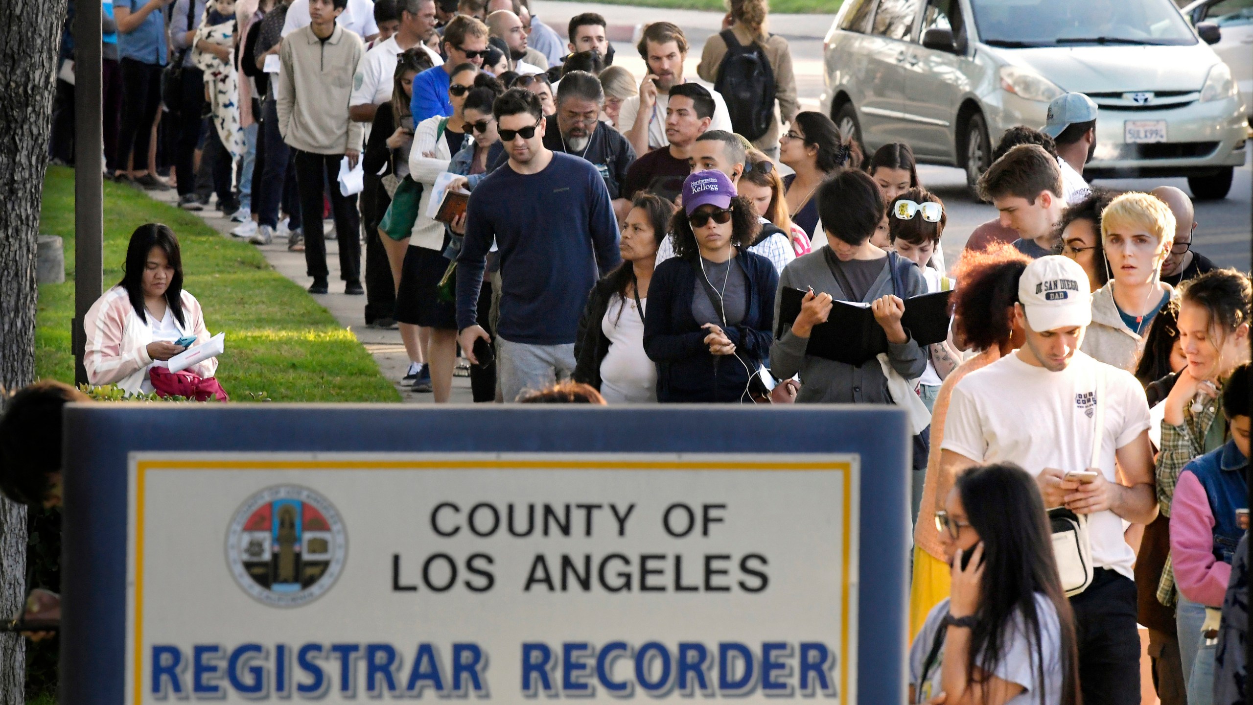 In this Nov. 6, 2018, file photo, potential voters wait in long lines to register and vote at the Los Angeles County Registrar's office in Norwalk. (Mark J. Terrill / Associated Press)