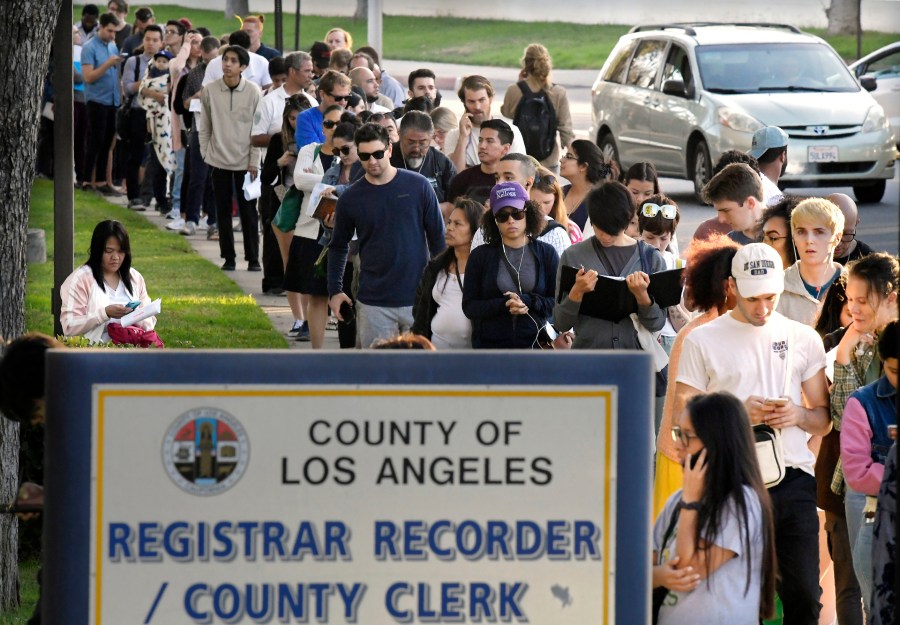 In this Nov. 6, 2018, file photo, potential voters wait in long lines to register and vote at the Los Angeles County Registrar's office in Norwalk. (Mark J. Terrill / Associated Press)