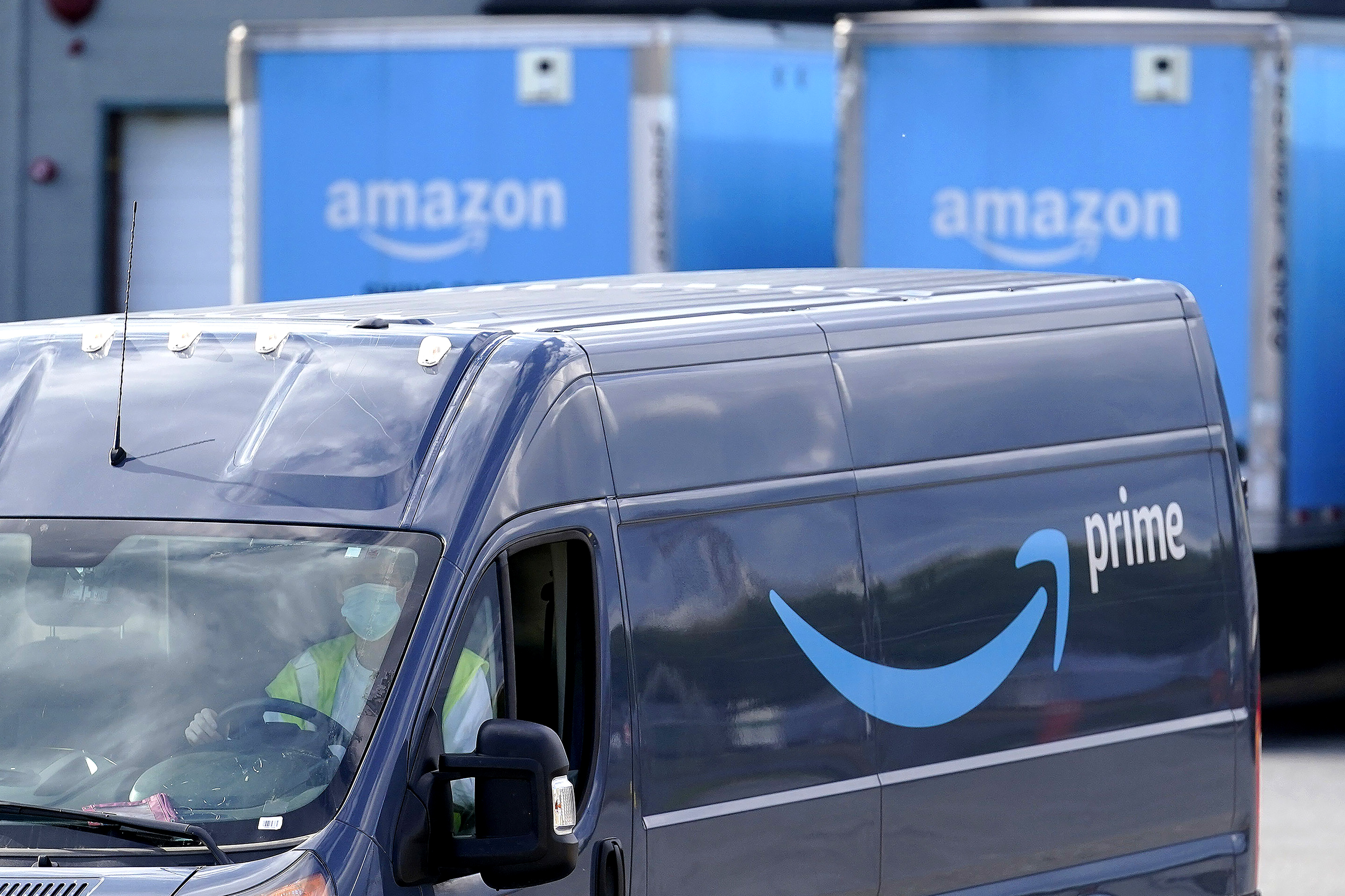 An Amazon Prime logo appears on the side of a delivery van as it departs an Amazon Warehouse location on Oct. 1, 2020, in Dedham, Mass. (Steven Senne / Associated Press)