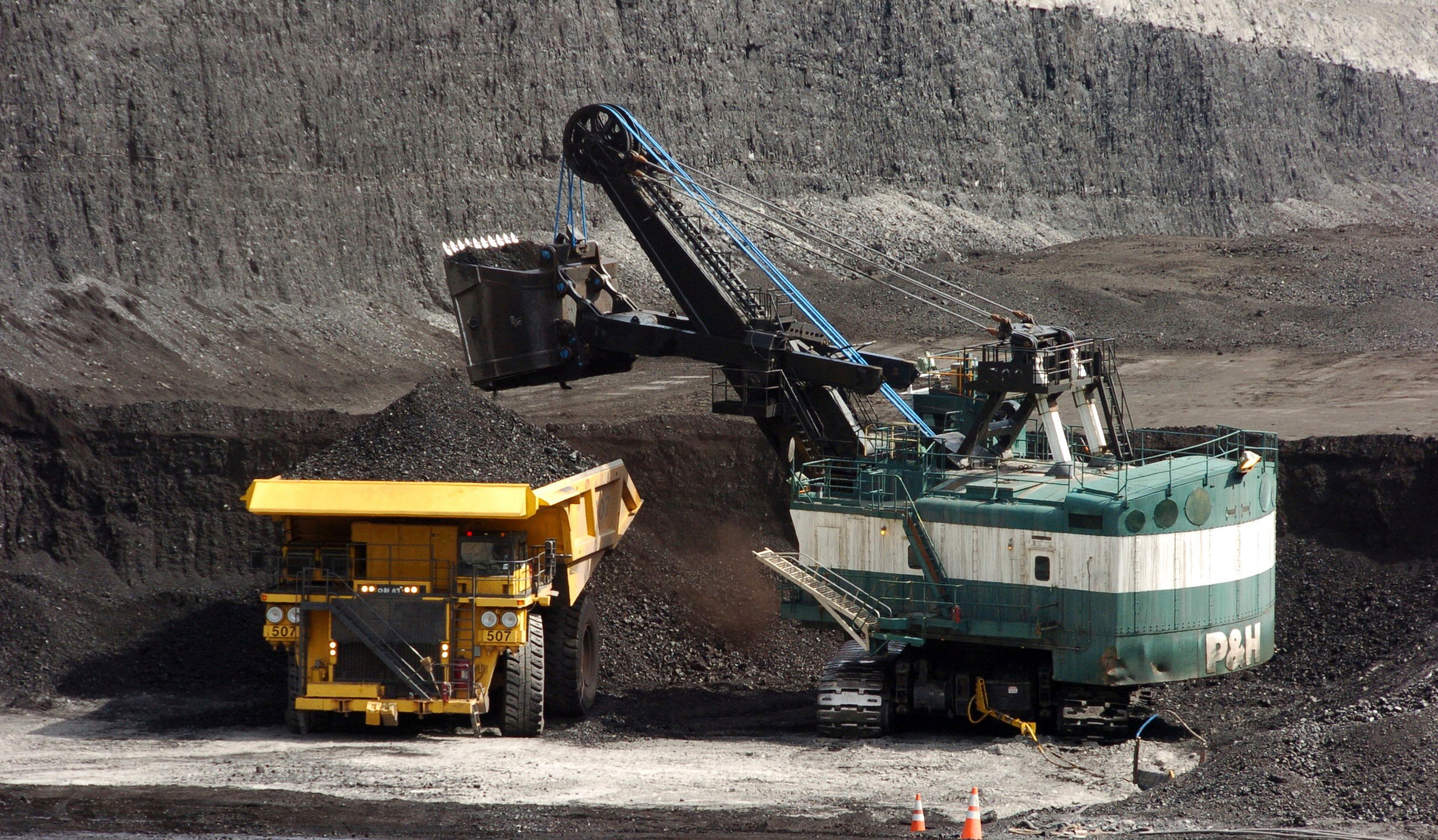 In this April 4, 2013, file photo, a mechanized shovel loads a haul truck with coal at the Spring Creek coal mine near Decker, Mont. (Matthew Brown/AP Photo)