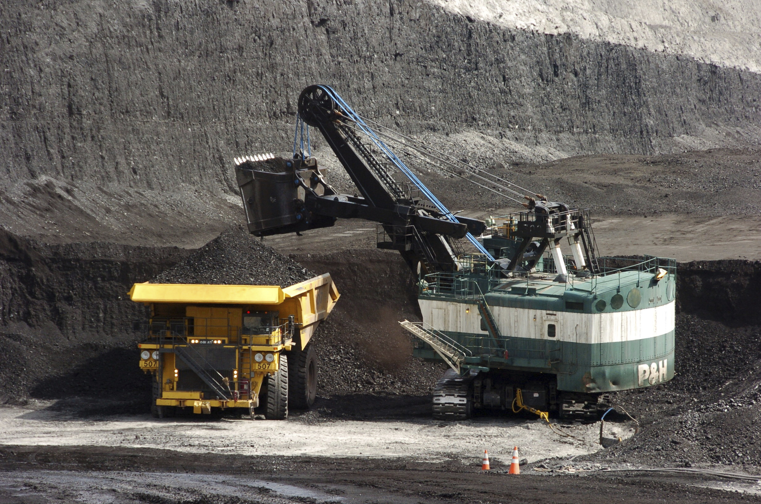 In this April 4, 2013, file photo, a mechanized shovel loads a haul truck with coal at the Spring Creek coal mine near Decker, Mont. (Matthew Brown/AP Photo)