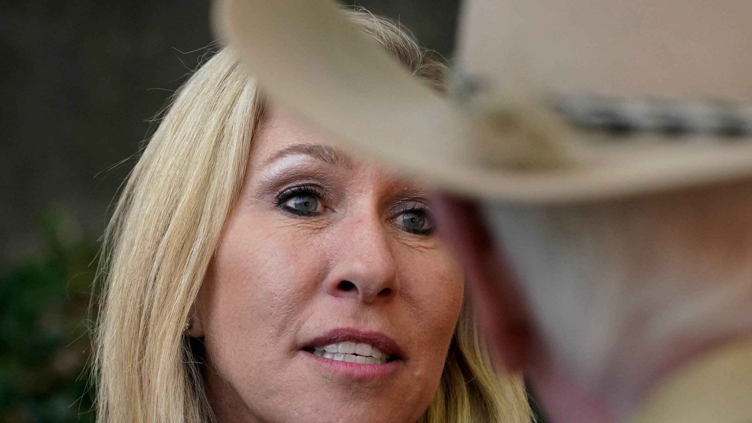 Republican candidate for Georgia's 14th congressional seat Marjorie Taylor Greene speaks to a man during a campaign rally Saturday, Oct. 31, 2020, in Roswell, Ga. (AP Photo/John Bazemore)