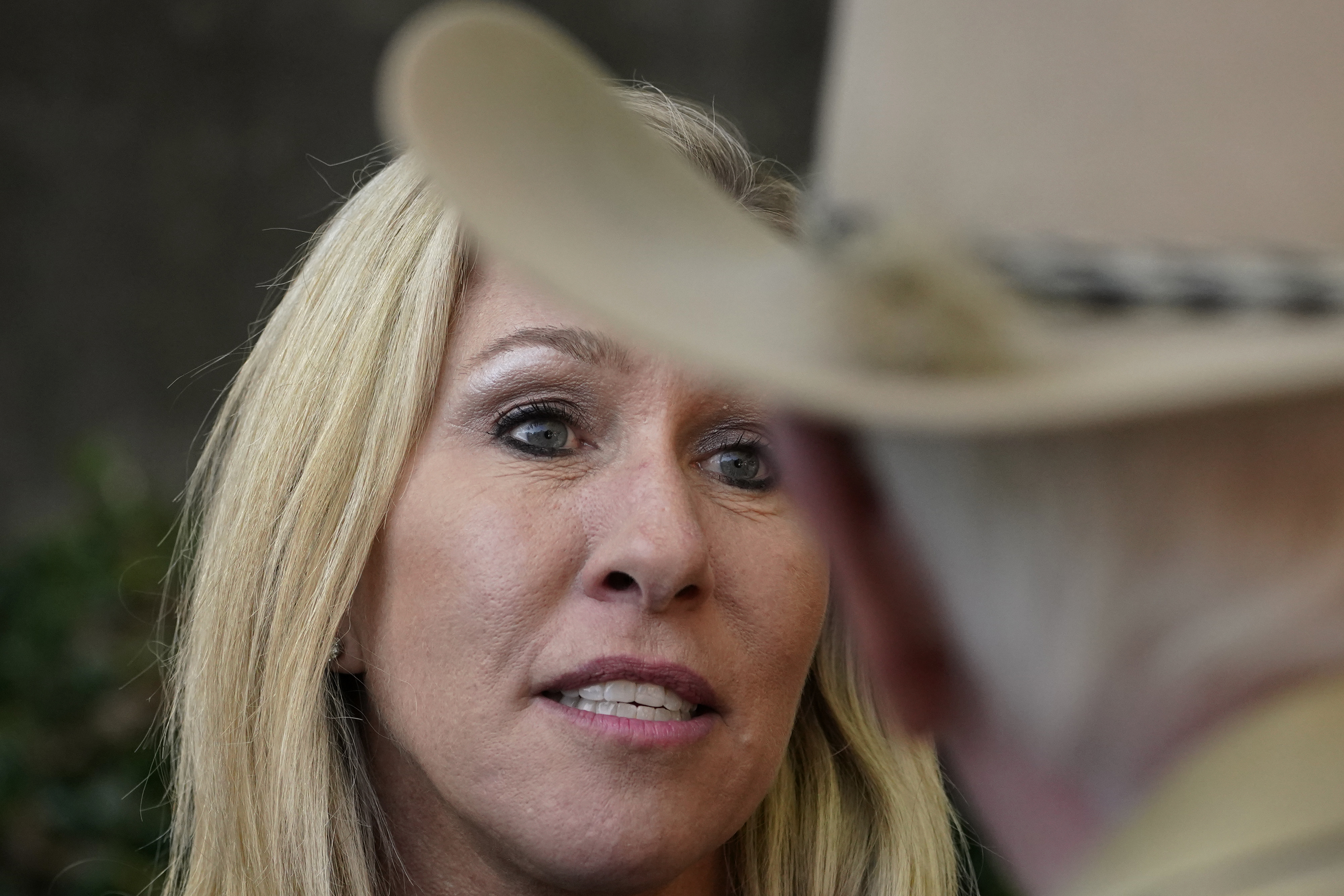 Republican candidate for Georgia's 14th congressional seat Marjorie Taylor Greene speaks to a man during a campaign rally Saturday, Oct. 31, 2020, in Roswell, Ga. (AP Photo/John Bazemore)