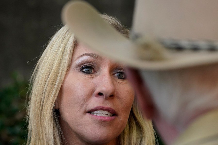 Republican candidate for Georgia's 14th congressional seat Marjorie Taylor Greene speaks to a man during a campaign rally Saturday, Oct. 31, 2020, in Roswell, Ga. (AP Photo/John Bazemore)