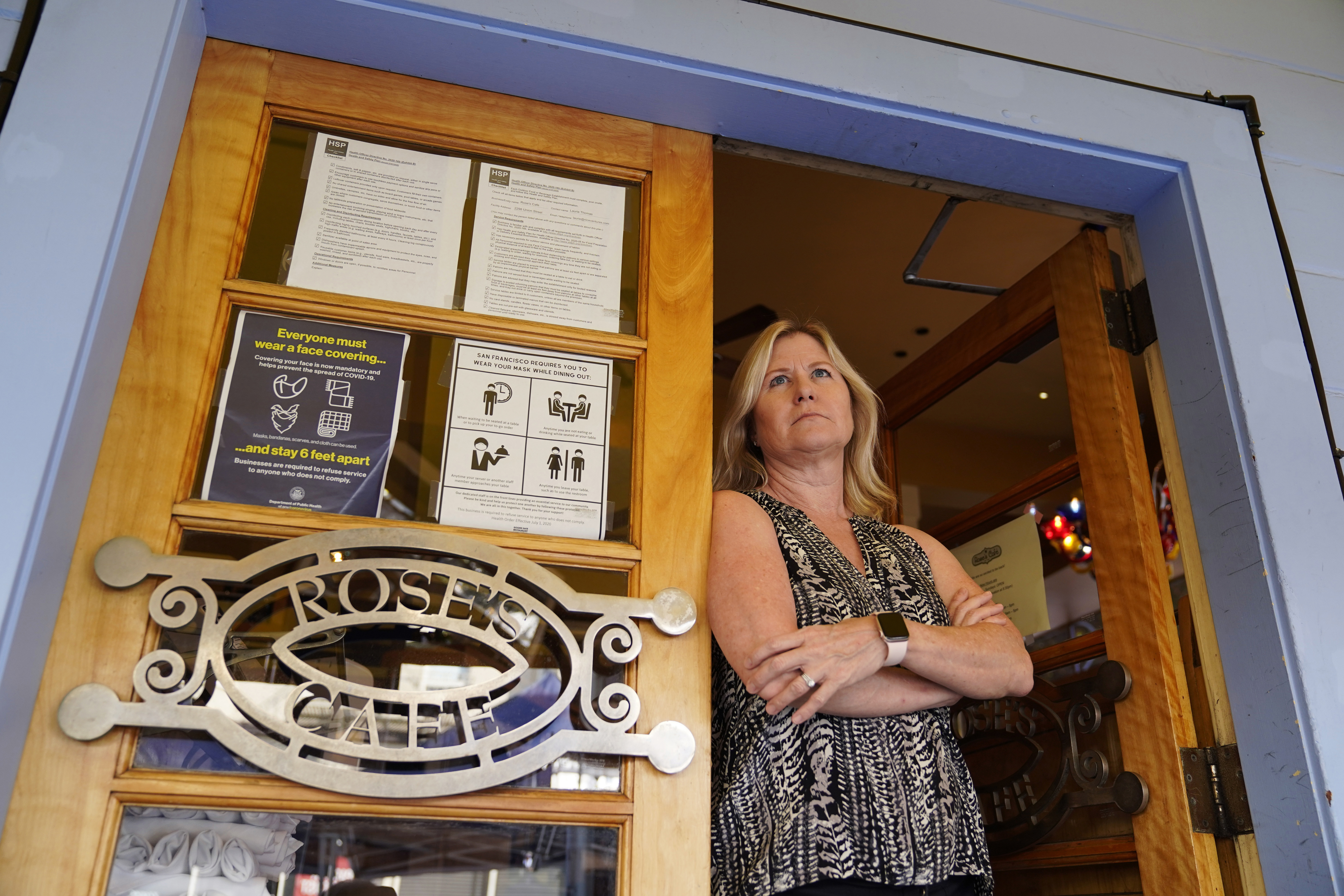 Laurie Thomas poses at the entrance to her Rose's Cafe restaurant in San Francisco on Sept. 28, 2020. (Eric Risberg / Associated Press)