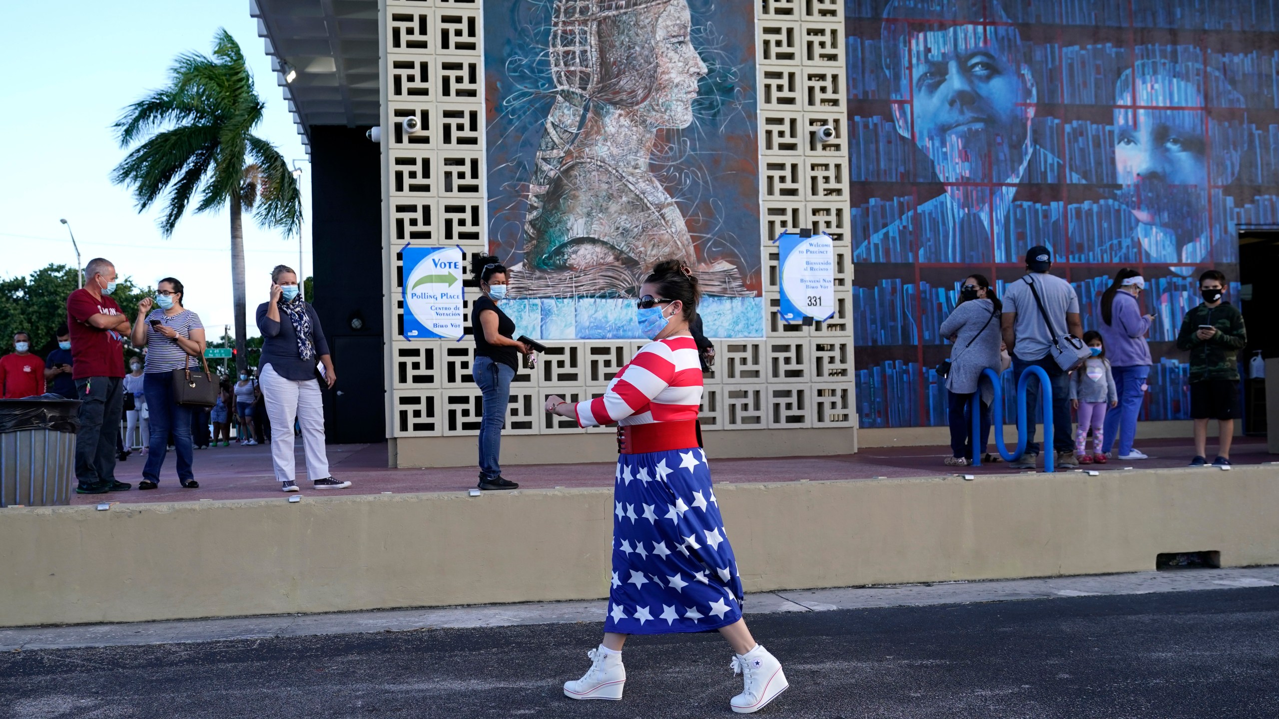 Yanitza Martinez wears red, white and blue as she arrives to vote outside of the John F. Kennedy Library in Hialeah, Florida, during the presidential election on Nov. 3, 2020. (Lynne Sladky / Associated Press)