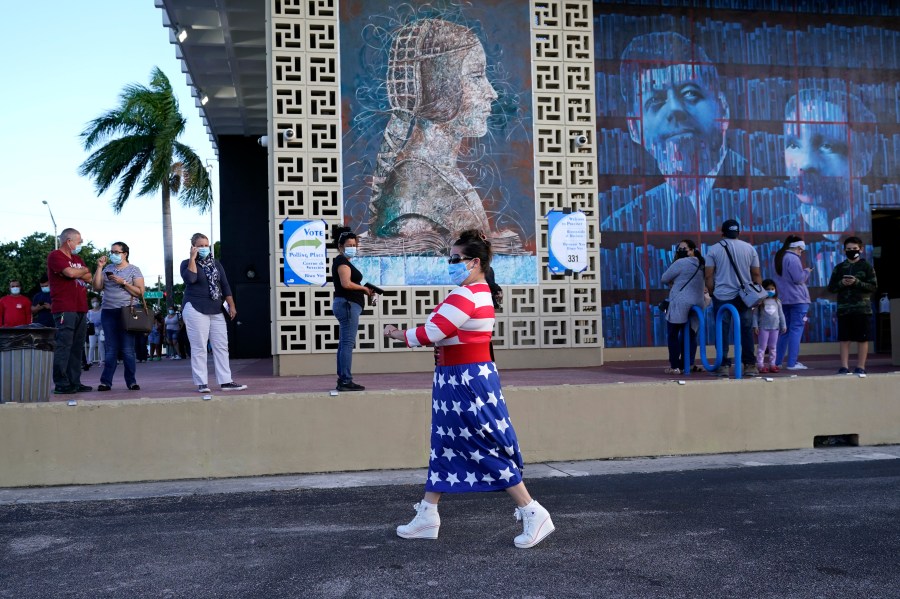 Yanitza Martinez wears red, white and blue as she arrives to vote outside of the John F. Kennedy Library in Hialeah, Florida, during the presidential election on Nov. 3, 2020. (Lynne Sladky / Associated Press)