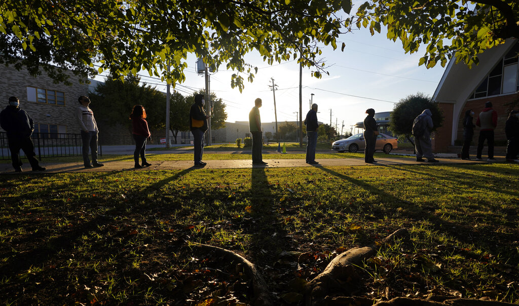 Voters line up outside Vickery Baptist Church waiting to cast their ballots on Election Day Tuesday, Nov. 3, 2020, in Dallas. (AP Photo/LM Otero)