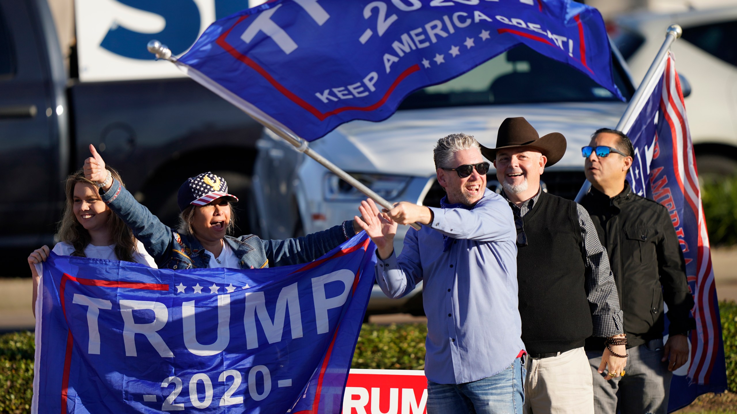 Supporters of President Trump cheer as passing cars honk their horns near a polling location in Houston on Election Day, Nov. 3, 2020. (David J. Phillip / Associated Press)