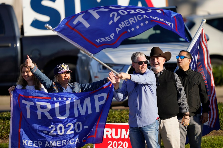 Supporters of President Trump cheer as passing cars honk their horns near a polling location in Houston on Election Day, Nov. 3, 2020. (David J. Phillip / Associated Press)