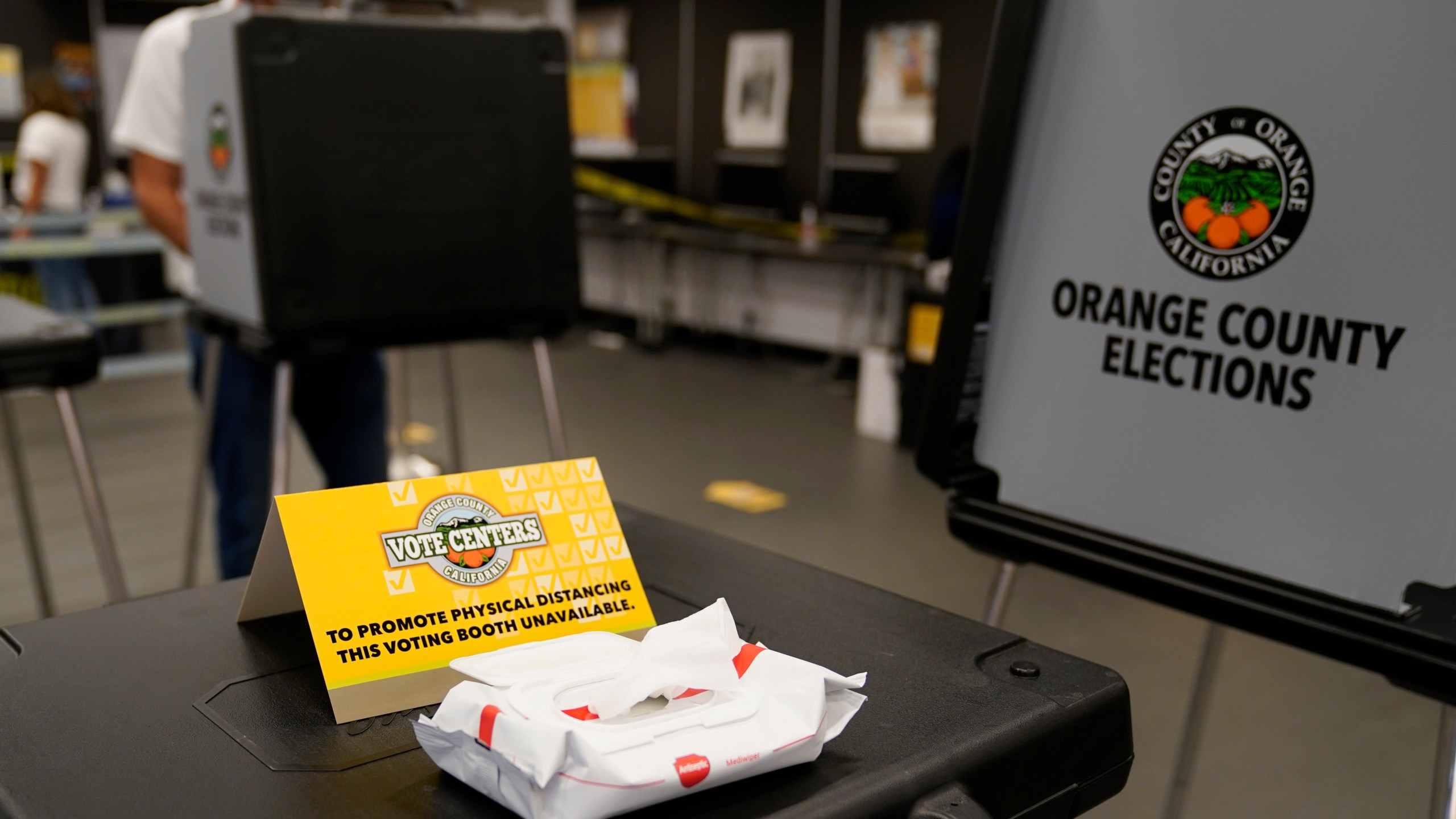 A sign designates physical distancing at a polling place Tuesday, Nov. 3, 2020, in Newport Beach, Calif. (AP Photo/Ashley Landis)