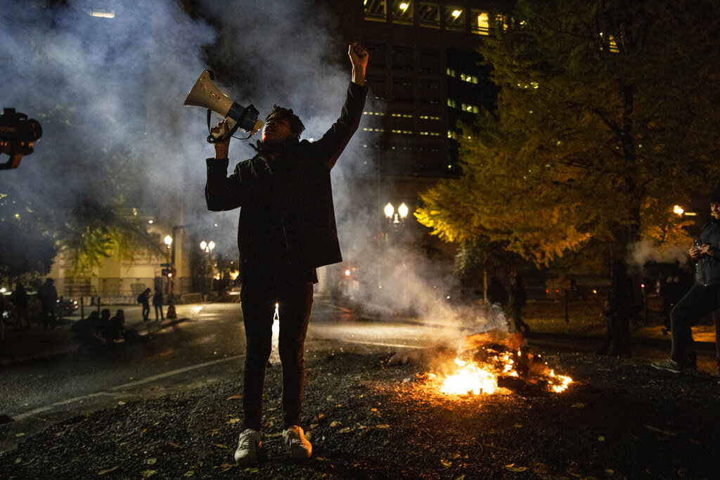 A Black Lives Matter protester chants slogans on Nov. 4, 2020, in Portland, Ore. (AP Photo/Paula Bronstein)