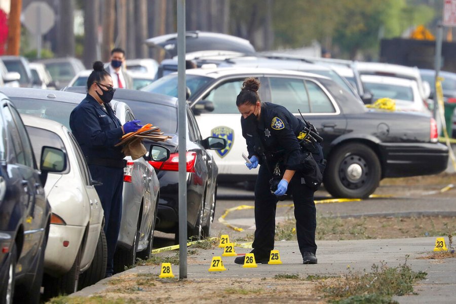 Members of the Oakland Police Department investigate the scene of an officer involved shooting on Wednesday, Nov. 4, 2020, in Oakland, Calif. (Aric Crabb/Bay Area News Group via AP)