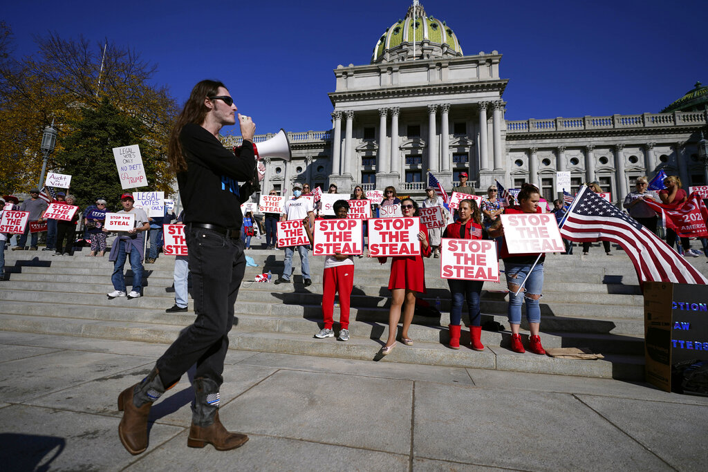 People demonstrate outside the Pennsylvania State Capitol, Friday, Nov. 6, 2020, in Harrisburg, Pa., as vote counting continues following Tuesday's election. (AP Photo/Julio Cortez)