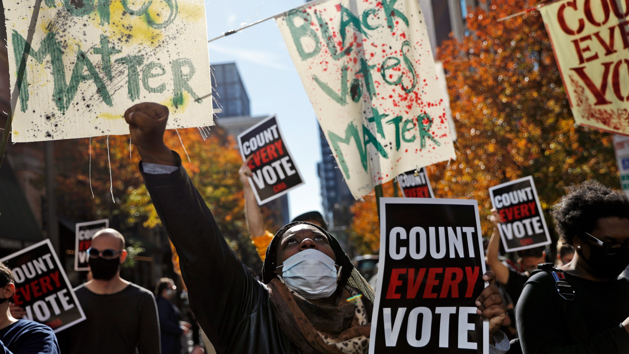 In this Nov. 5, 2020, file photo, Zhanon Morales, 30, of Philadelphia, raises her fist as demonstrators call for all votes be counted during a rally outside the Pennsylvania Convention Center in Philadelphia, as vote counting in the general election continues. (Rebecca Blackwell/AP Photo)