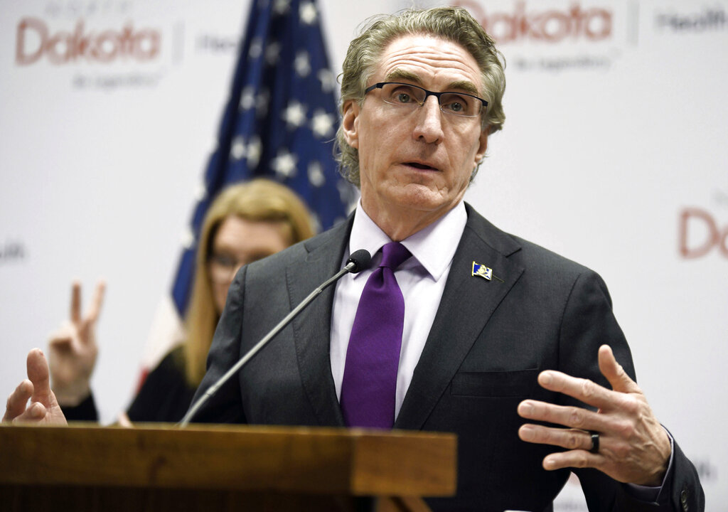 In this April 10, 2020, file photo, North Dakota Gov. Doug Burgum speaks at the state Capitol in Bismarck, N.D. North Dakota and South Dakota have the nation's worst rate of coronavirus deaths per capita in the last 30 days. Despite advances in treating coronavirus patients, hundreds more people in the Dakotas have died in recent weeks than during any other time of the pandemic. (Mike McCleary/The Bismarck Tribune via AP, File)