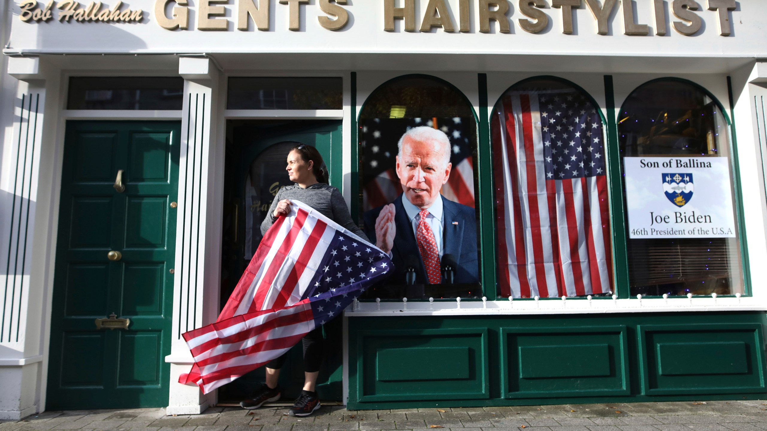 Catherine Hallahan waits for the celebrations to start in Ballina, North West of Ireland Saturday, Nov. 7, 2020. Ballina is the ancestral home of US Presidential candidate Joe Biden. (AP Photo/Peter Morrison)