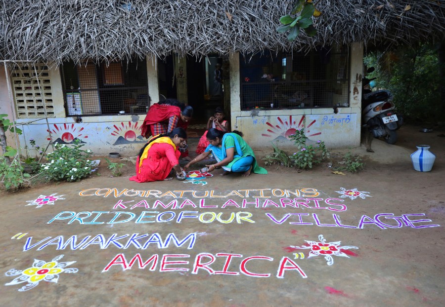 Indian women prepare a Kolam, a traditional art work using colored powder, congratulating U.S. Vice President-elect Kamala Harris in the hometown of Harris' maternal grandfather, in Thulasendrapuram, south of Chennai, Tamil Nadu state, India, Sunday, Nov. 8, 2020. (AP Photo/Aijaz Rahi)