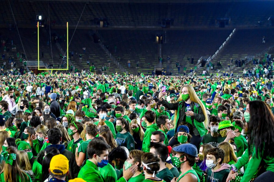 Fans storm the field after Notre Dame defeated the Clemson 47-40 in two overtimes in an NCAA college football game Saturday, Nov. 7, 2020, in South Bend, Ind. (Matt Cashore/Pool Photo via AP)