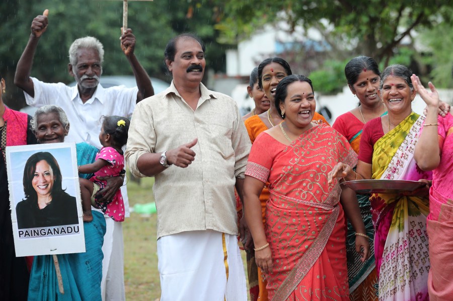 Villagers celebrate the victory of U.S. Vice President-elect Kamala Harris in Painganadu a neighboring village of Thulasendrapuram, the hometown of Harris' maternal grandfather, south of Chennai, Tamil Nadu state, India, Sunday, Nov. 8, 2020. Waking up to the news of Kamala Harris' election as Joe Biden's running mate, overjoyed people in her Indian grandfather's hometown are setting off firecrackers, carrying her placards and offering prayers. (AP Photo/Aijaz Rahi)