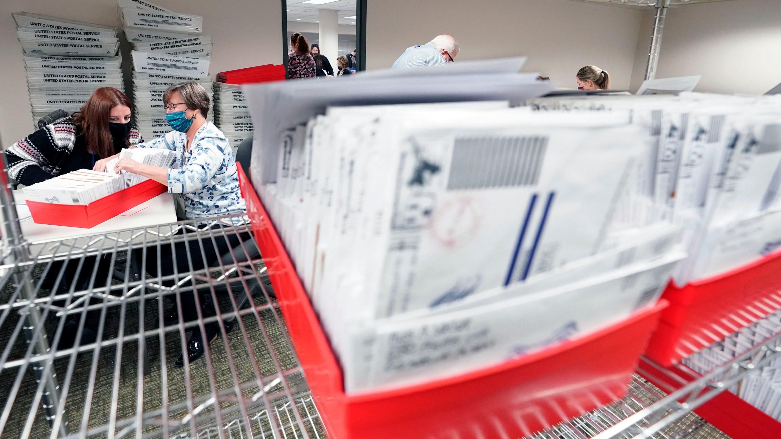 In this Nov. 5, 2020, photo, Lehigh County workers count ballots as vote counting in the general election continues in Allentown, Pa. (AP Photo/Mary Altaffer)