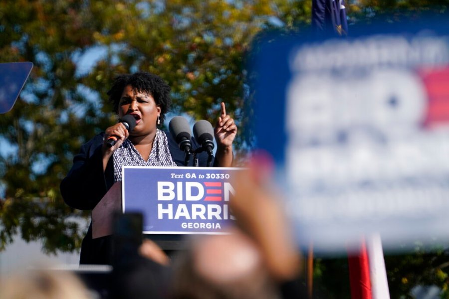 In this Nov. 2, 2020, photo, Stacey Abrams speaks to supporters as they wait for former President Barack Obama to arrive and speak at a rally as he campaigns for Democratic presidential candidate former Vice President Joe Biden, at Turner Field in Atlanta. (AP Photo/Brynn Anderson)