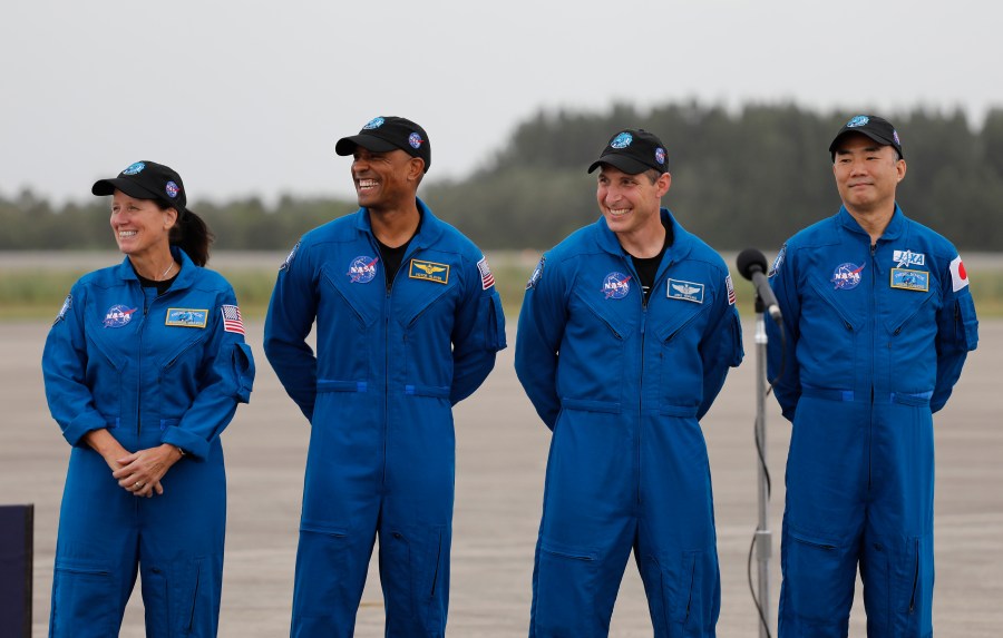 NASA Astronauts from left Shannon Walker, Victor Glover, Michael Hopkins and Japan Aerospace Exploration Agency Astronaut Soichi Noguchi smile during a news conference after they arrived at the Kennedy Space Center, Sunday, Nov. 8, 2020, in Cape Canaveral, Fla. (AP Photo/Terry Renna)