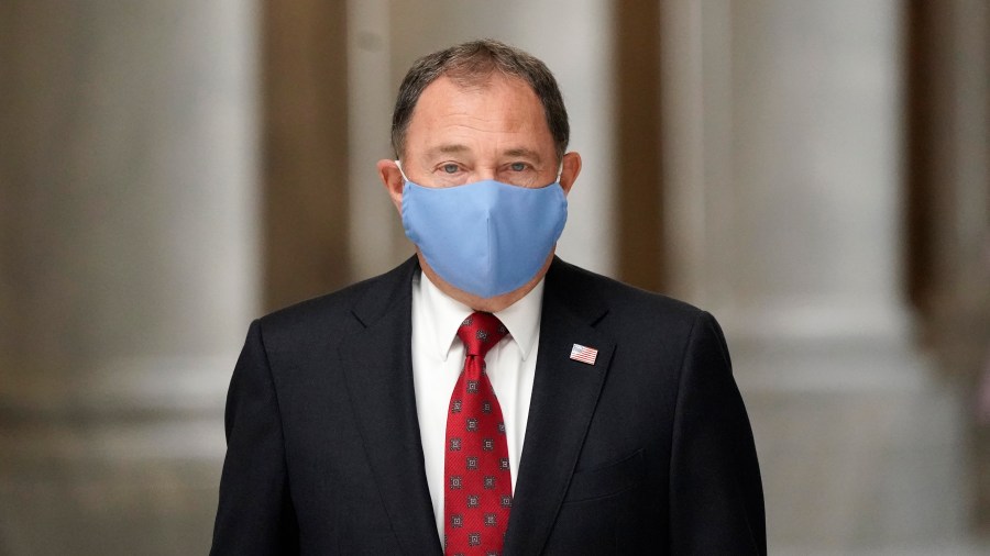 In this Sept. 22, 2020, file photo, Utah Gov. Gary Herbert walks through the Capitol rotunda to a COVID-19 briefing, in Salt Lake City. Herbert declared a state of emergency, Sunday, Nov. 8, 2020, and ordered a statewide mask mandate in an attempt to stem a surge in coronavirus patient hospitalizations that is testing the state's hospital capacity. (AP Photo/Rick Bowmer, File)