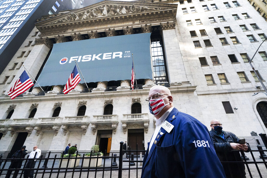 Stock trader Thomas Ferrigno arrives to work at the New York Stock Exchange, Monday, Nov. 9, 2020. (AP Photo/Mark Lennihan)