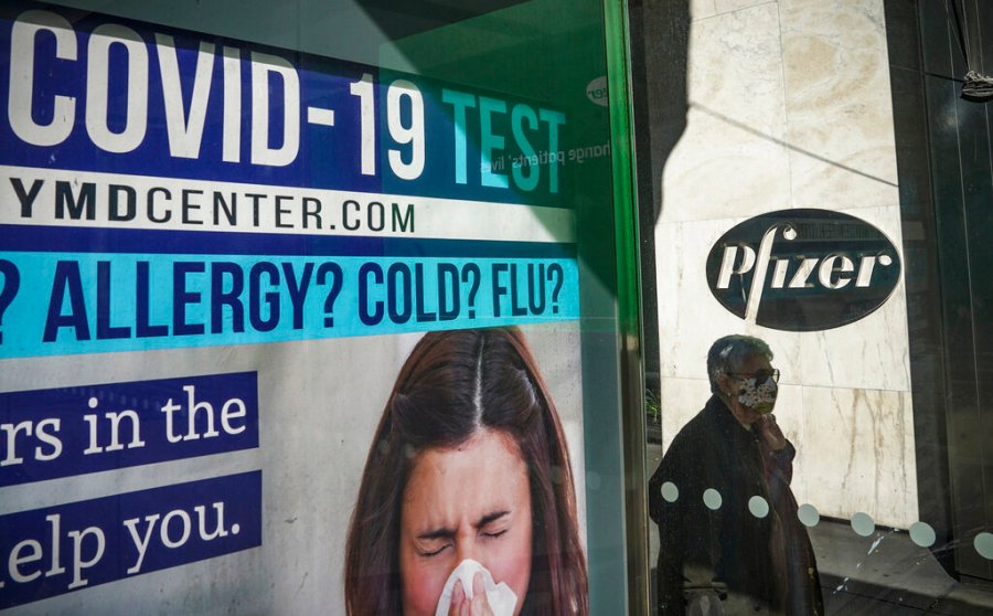 A bus stop ad for COVID-19 testing is shown outside Pfizer world headquarters in New York on Nov. 9, 2020.(AP Photo/Bebeto Matthews)