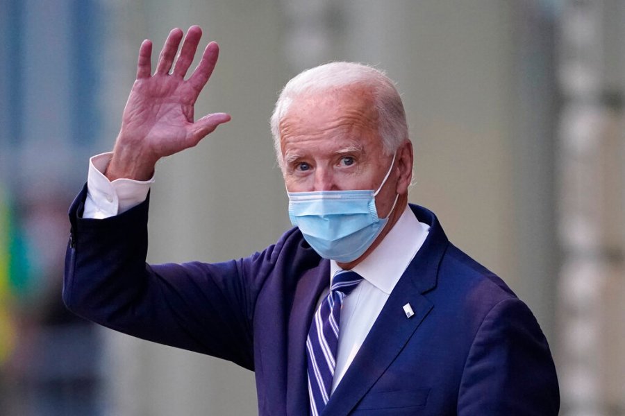 President-elect Joe Biden wavs as he leaves The Queen theater on Nov. 10, 2020, in Wilmington, Del. (AP Photo/Carolyn Kaster)