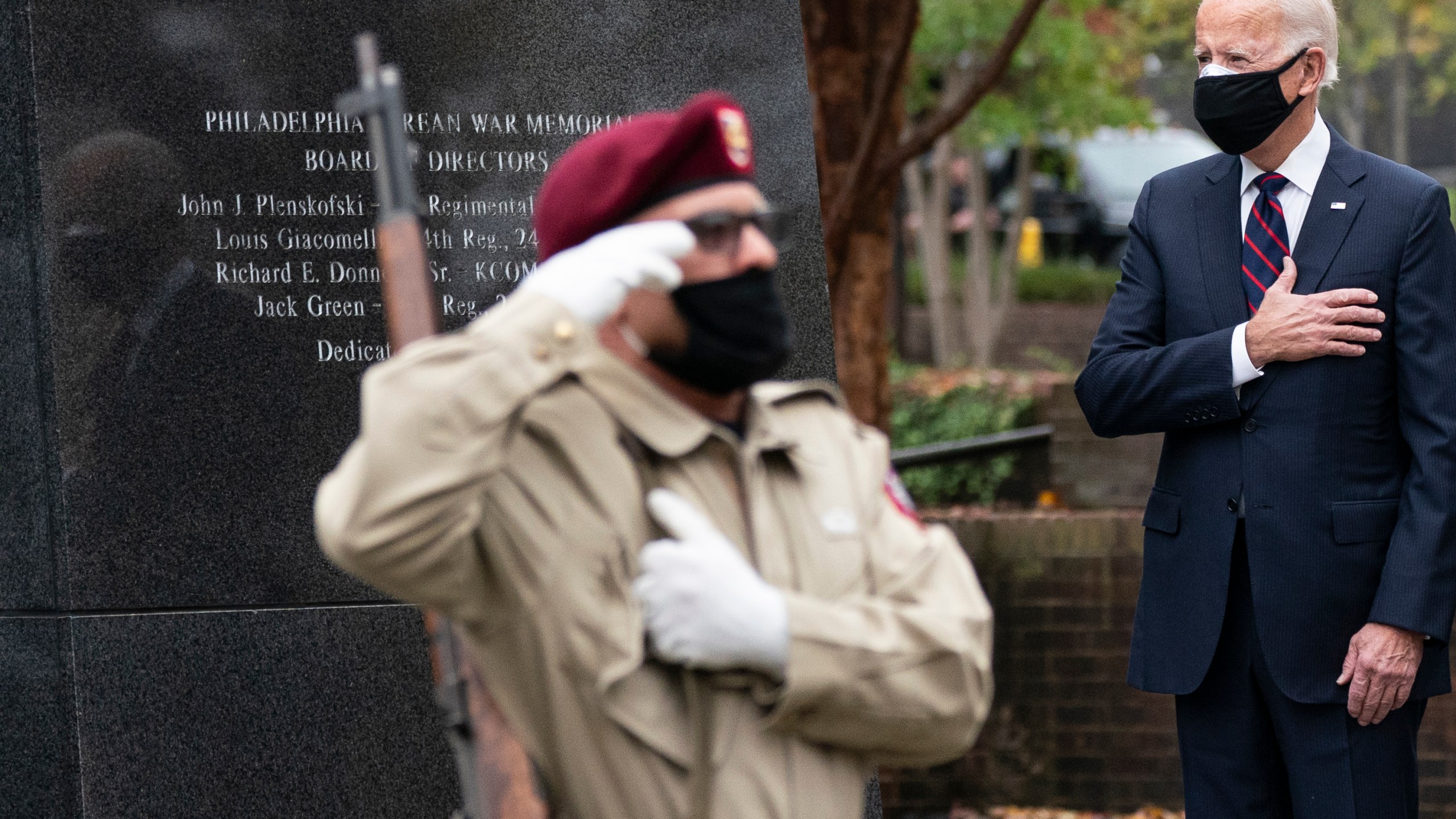 President-elect Joe Biden stands with his hand over his heart, after placing a wreath at the Philadelphia Korean War Memorial at Penn's Landing, on Veterans Day, Nov. 11, 2020, in Philadelphia. (Alex Brandon/Associated Press)