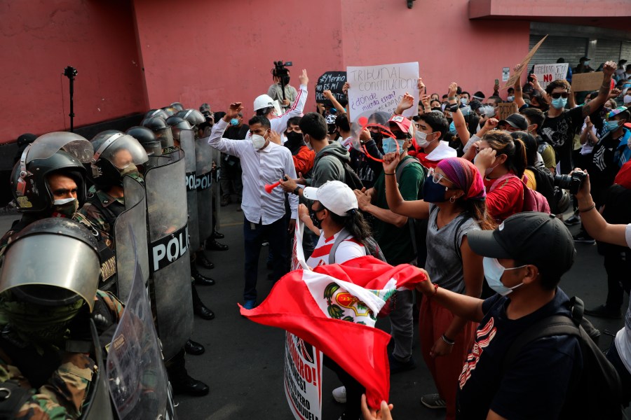 Supporters of ousted President Martin Vizcarra shout at police to let them pass as they try to march to Congress in Lima, Peru, Wednesday, Nov. 11, 2020. (Rodrigo Abd/AP Photo)