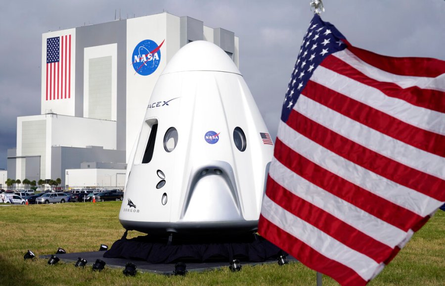 A mockup of the SpaceX crew capsule is seen on display in front of the Vehicle Assembly Building during a news conference at the Kennedy Space Center in Cape Canaveral, Fla., Friday, Nov. 13, 2020. (AP Photo/John Raoux)