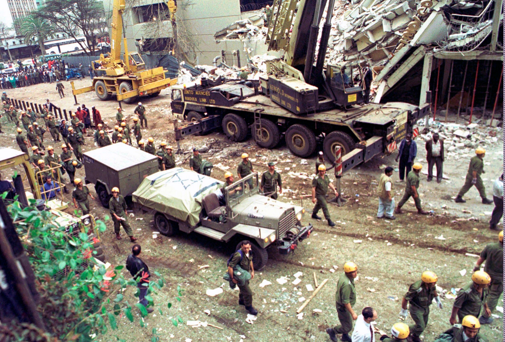 In this Sunday, Aug. 9, 1998 file photo, Israeli soldiers bring in heavy lifting equipment to the wreckage of the Ufundi House, adjacent to the U.S. embassy in Nairobi. (Sayyid Azim/AP Photo)