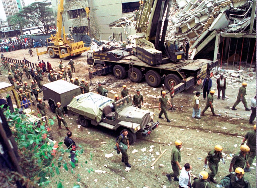 In this Sunday, Aug. 9, 1998 file photo, Israeli soldiers bring in heavy lifting equipment to the wreckage of the Ufundi House, adjacent to the U.S. embassy in Nairobi. (Sayyid Azim/AP Photo)