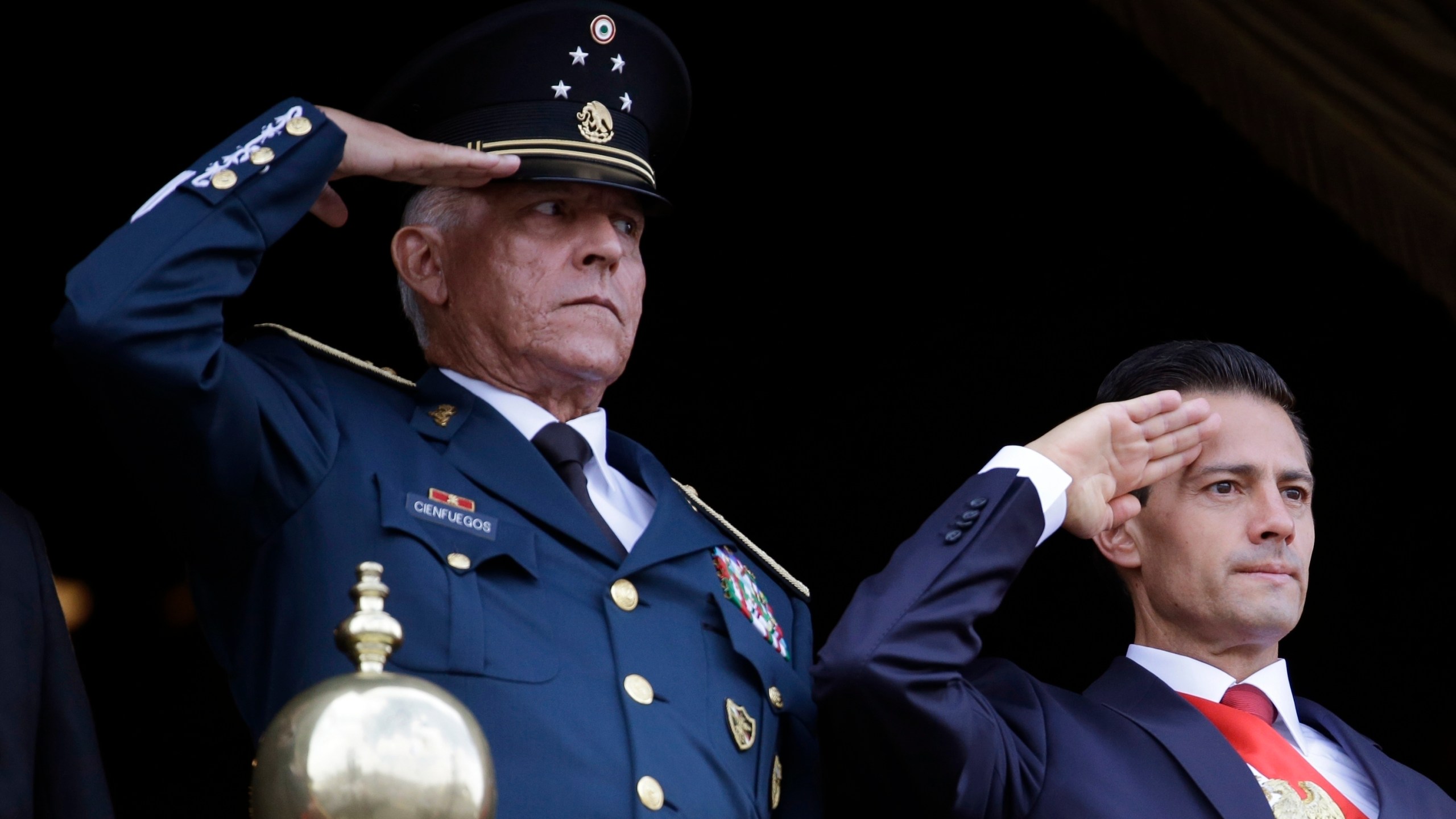 In this Sept. 16, 2016, file photo, Defense Secretary Gen. Salvador Cienfuegos, left, and Mexico's President Enrique Pena Nieto, salute during the annual Independence Day military parade in Mexico City's main square. (Rebecca Blackwell / Associated Press)