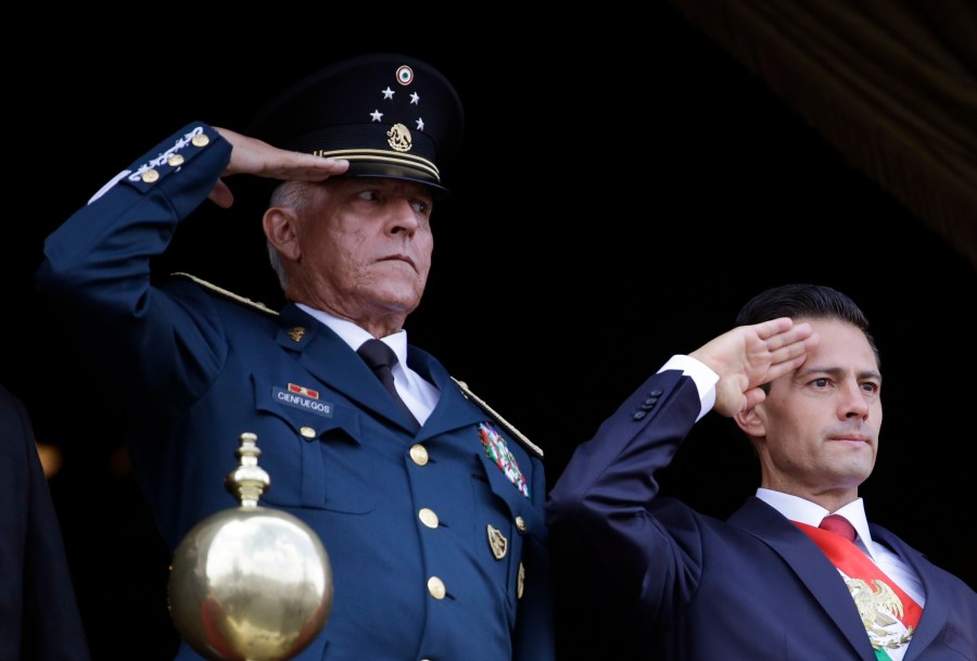 In this Sept. 16, 2016, file photo, Defense Secretary Gen. Salvador Cienfuegos, left, and Mexico's President Enrique Pena Nieto, salute during the annual Independence Day military parade in Mexico City's main square. (Rebecca Blackwell / Associated Press)