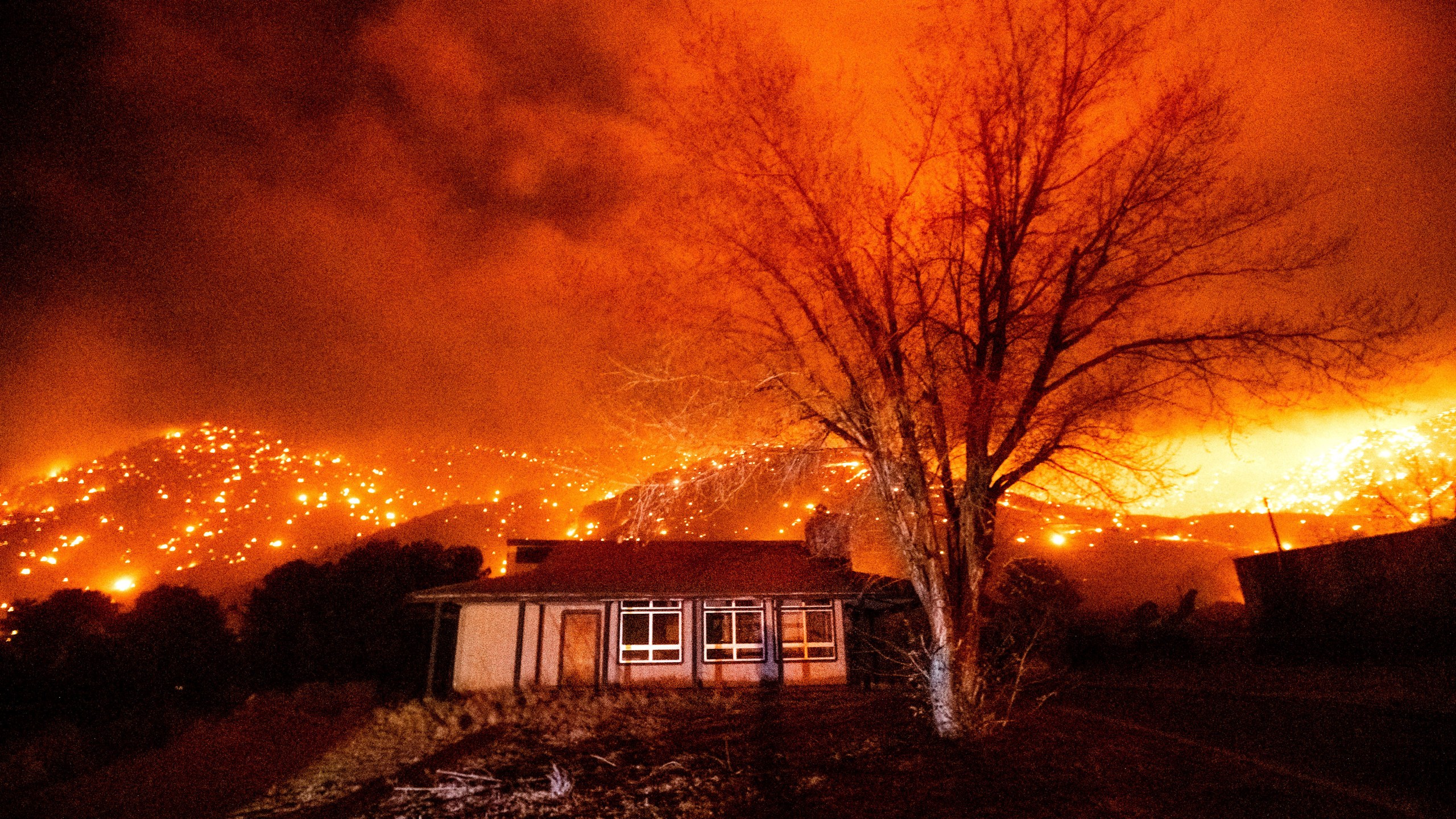 Embers burn along hillsides as the Mountain View Fire tears through the Walker community in Mono County, Calif., on Tuesday, Nov. 17, 2020. (AP Photo/Noah Berger)