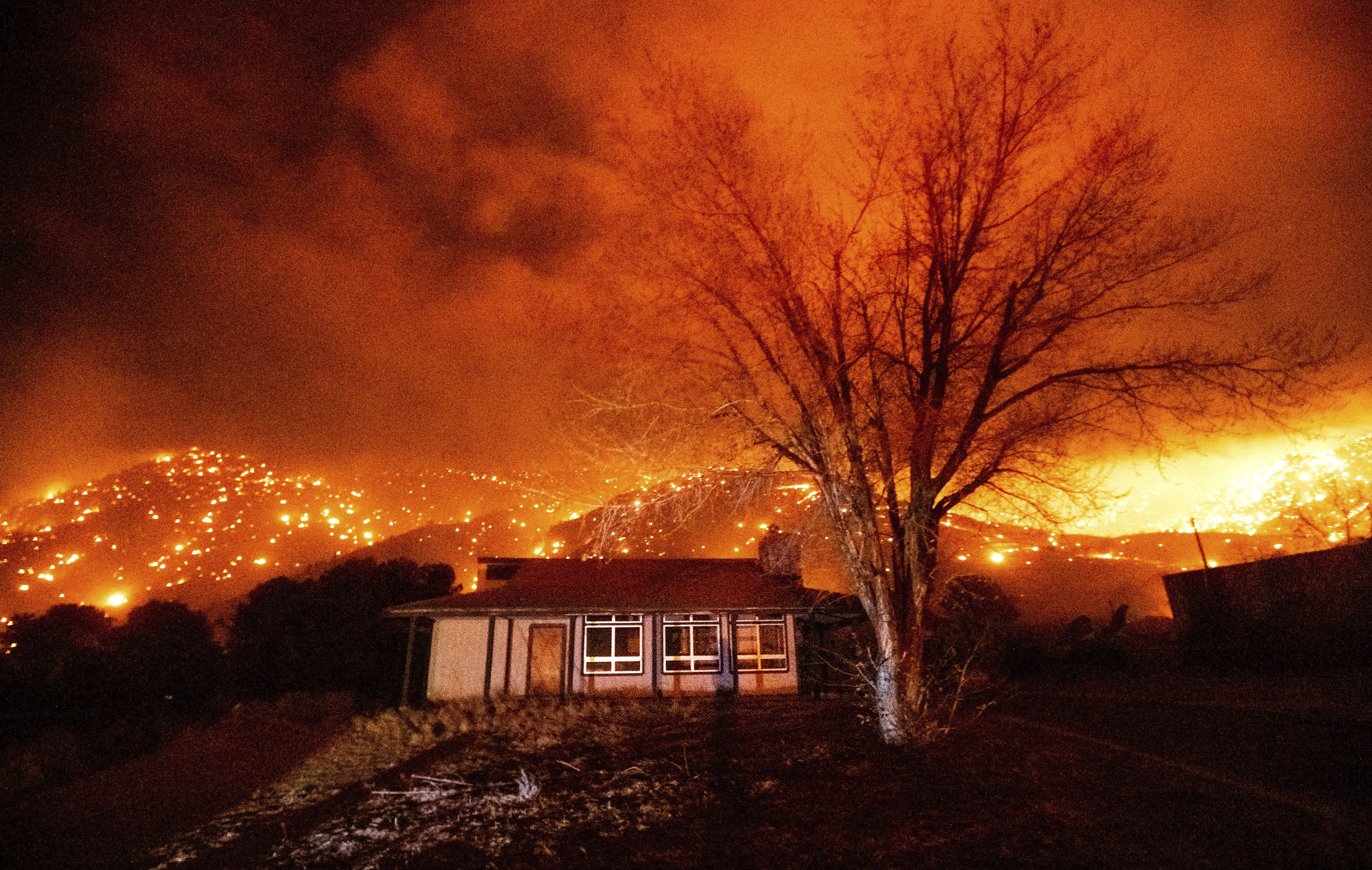 Embers burn along hillsides as the Mountain View Fire tears through the Walker community in Mono County, Calif., on Tuesday, Nov. 17, 2020. (AP Photo/Noah Berger)