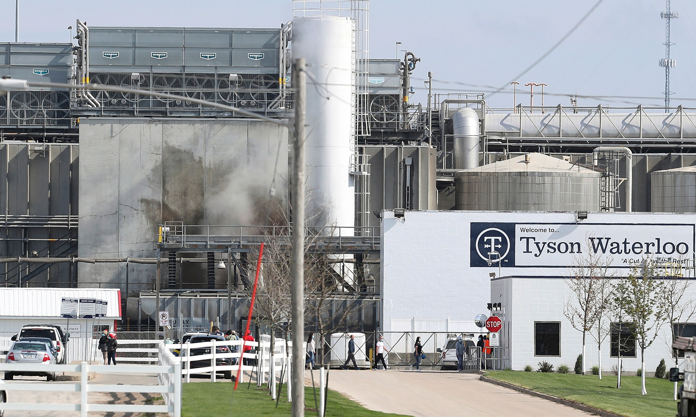 In this May 2020 file photo, Tyson's Fresh Meat workers file in for a tour of safety measures put into place after the plant in Waterloo, Iowa, had to shut down due to a COVID-19 outbreak. (Brandon Pollock / The Courier via Associated Press)