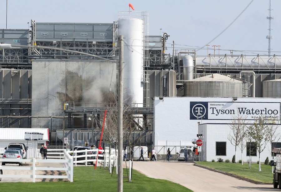 In this May 2020 file photo, Tyson's Fresh Meat workers file in for a tour of safety measures put into place after the plant in Waterloo, Iowa, had to shut down due to a COVID-19 outbreak. (Brandon Pollock / The Courier via Associated Press)