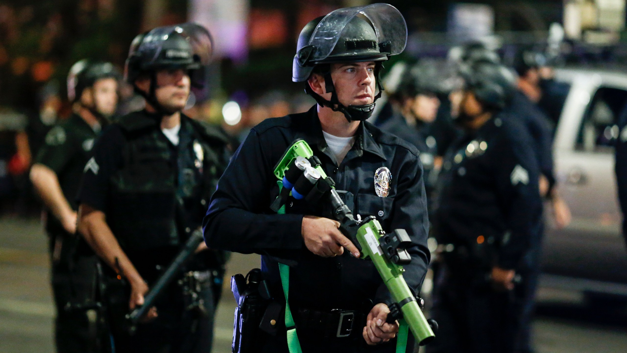 Police officers stand guard as they clear the streets during a protest in Los Angeles following the presidential election on Nov. 4, 2020. (Ringo H.W. Chiu / Associated Press)