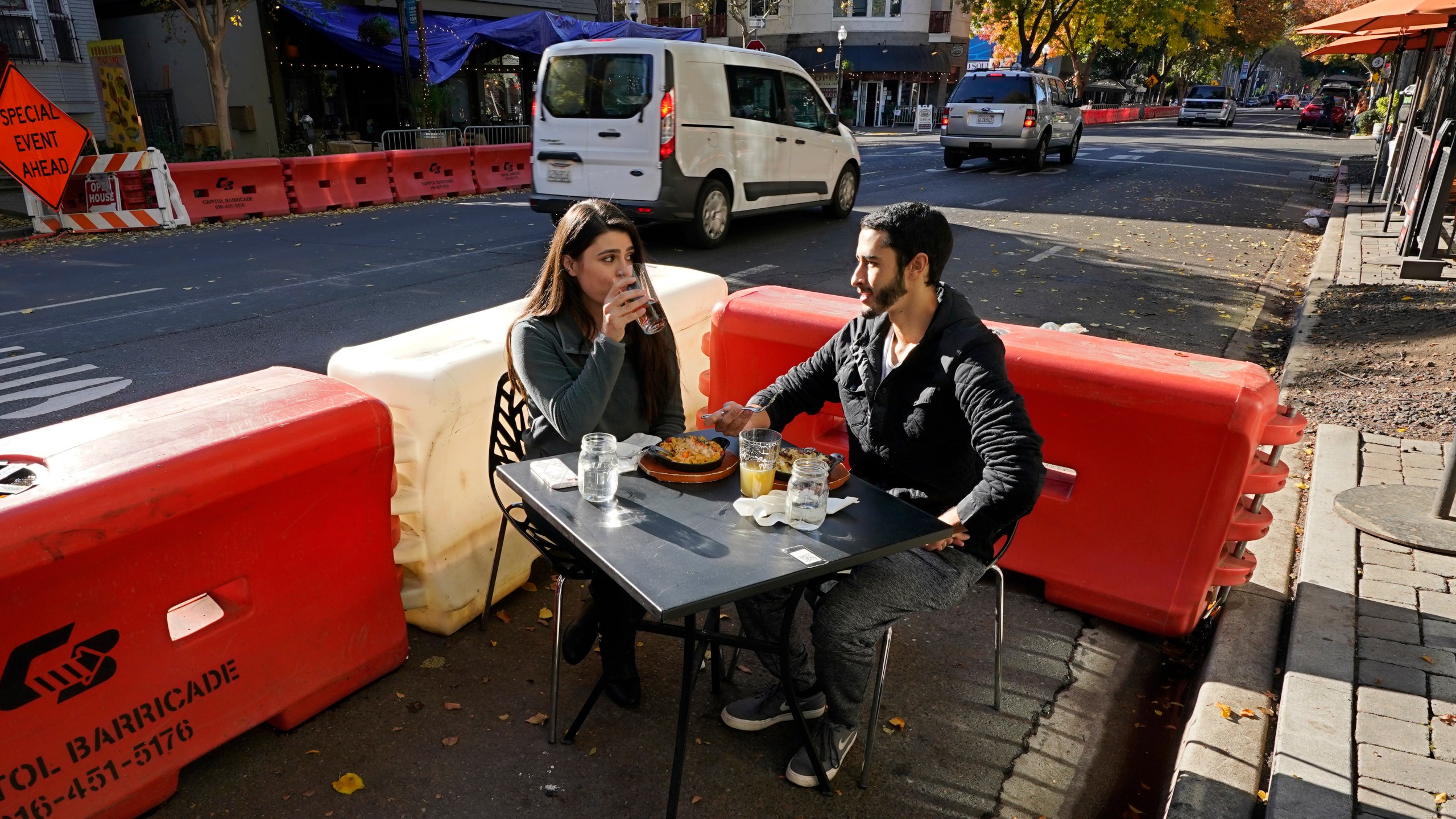 Ranim Abaad and Joey Bettencourt, right, have lunch at the RIND in Sacramento on Nov. 20, 2020. (Rich Pedroncelli / Associated Press)