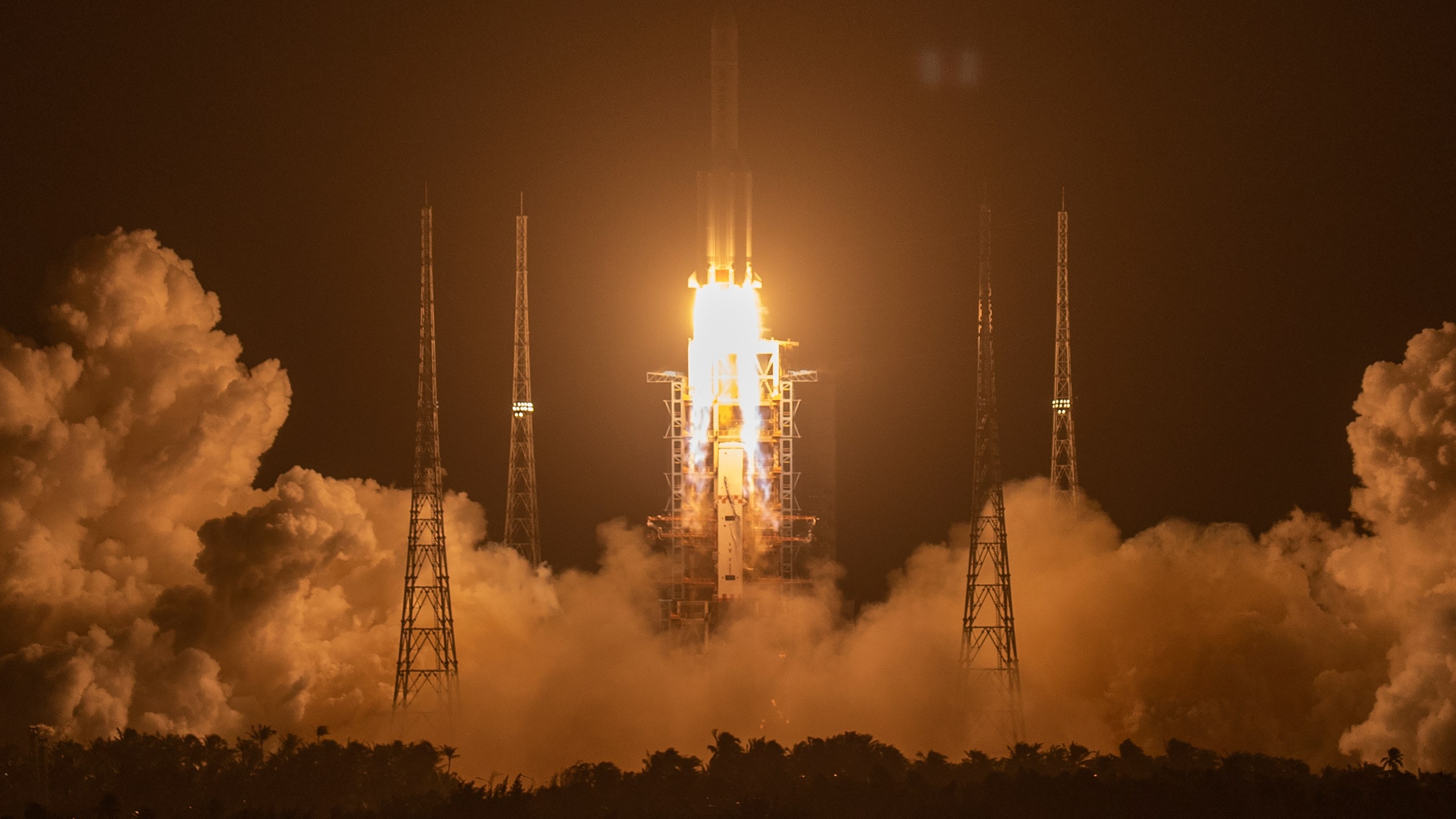 A Long March-5 rocket carrying the Chang'e 5 lunar mission lifts off at the Wenchang Space Launch Center in Wenchang in southern China's Hainan Province on Nov. 24, 2020. (AP Photo/Mark Schiefelbein)