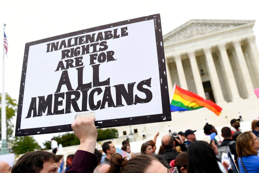 In this Oct. 8, 2019, file photo, protesters gather outside the Supreme Court in Washington where the Supreme Court is hearing arguments in the first case of LGBT rights since the retirement of Supreme Court Justice Anthony Kennedy. (AP Photo/Susan Walsh, File)